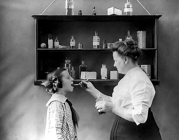Mother Giving Medicine to Child